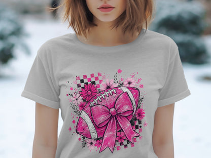Pink football with bow and flowers on a checkered background.