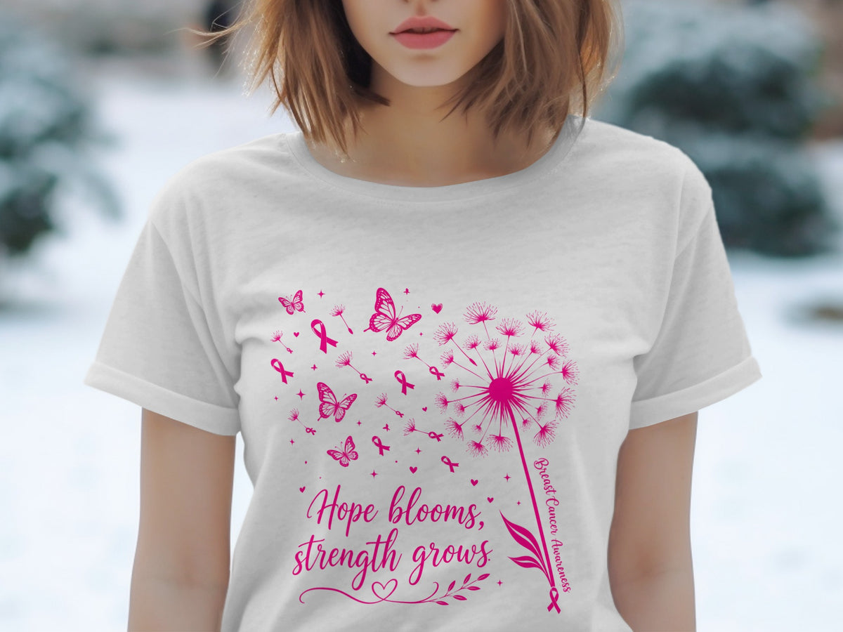 White t-shirt with pink dandelion, butterflies, ribbons, and text "Hope blooms, strength grows".