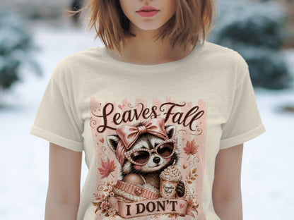 Raccoon with sunglasses and pumpkin spice latte graphic on a cream t-shirt.