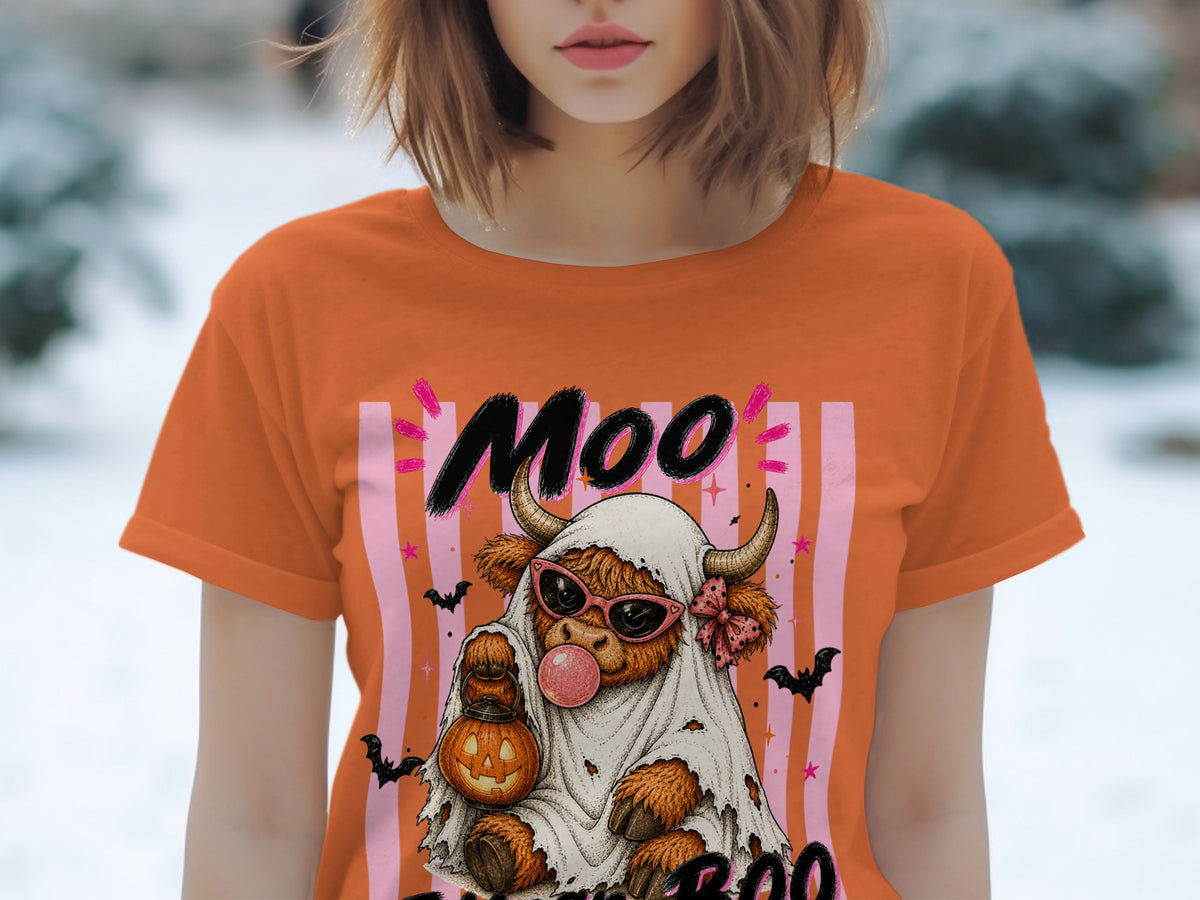 Orange t-shirt with cow dressed as ghost, holding pumpkin lantern, and text "Moo".