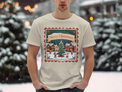 T-shirt with a Christmas village scene featuring children skating and a decorated tree.