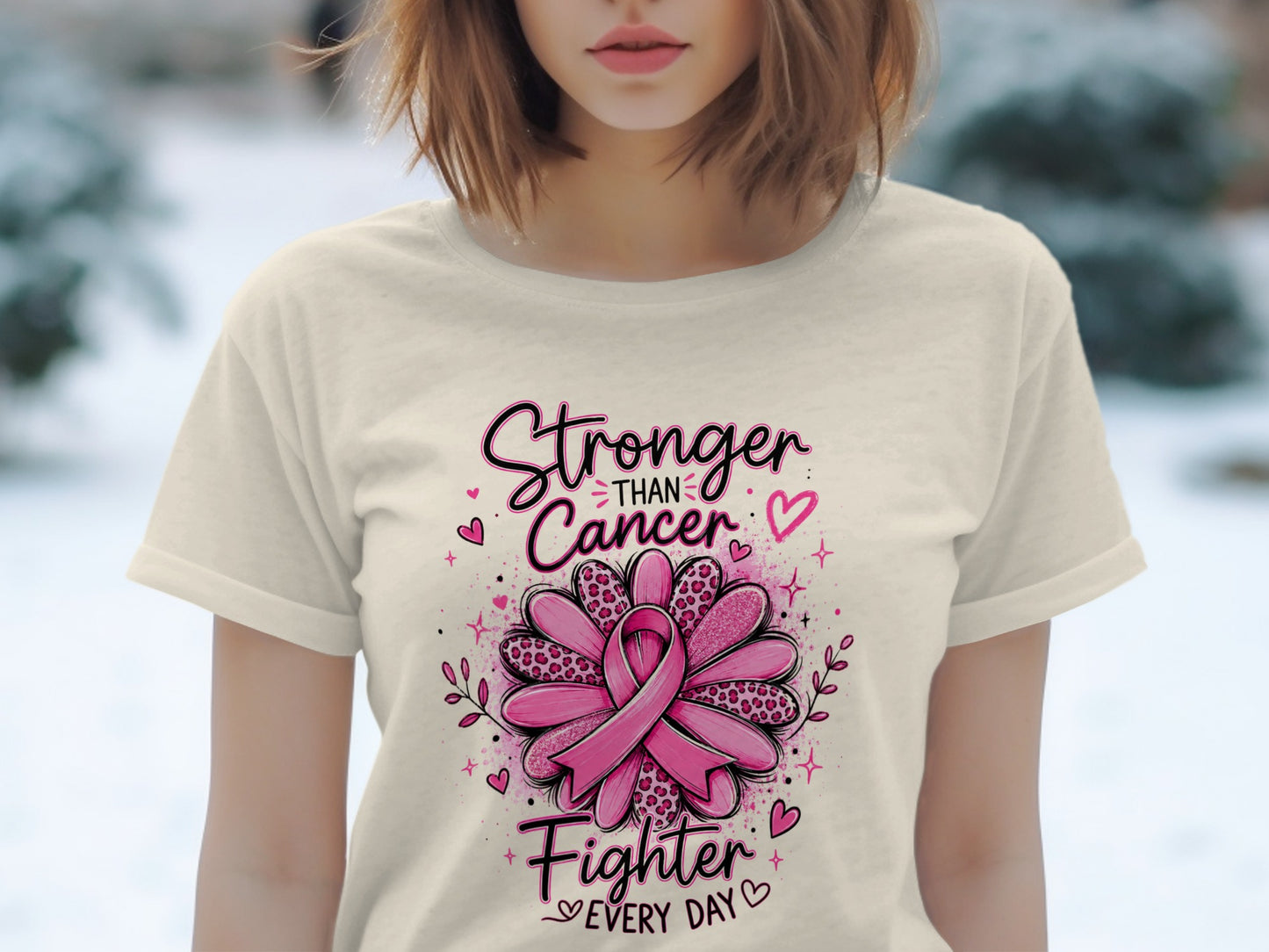 Cream t-shirt with "Stronger Than Cancer Fighter Every Day" text and pink ribbon graphic.
