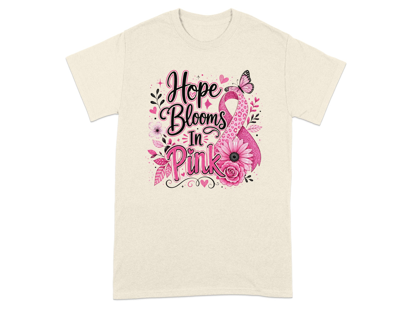 Cream t-shirt with "Hope Blooms In Pink" text and pink ribbon design.
