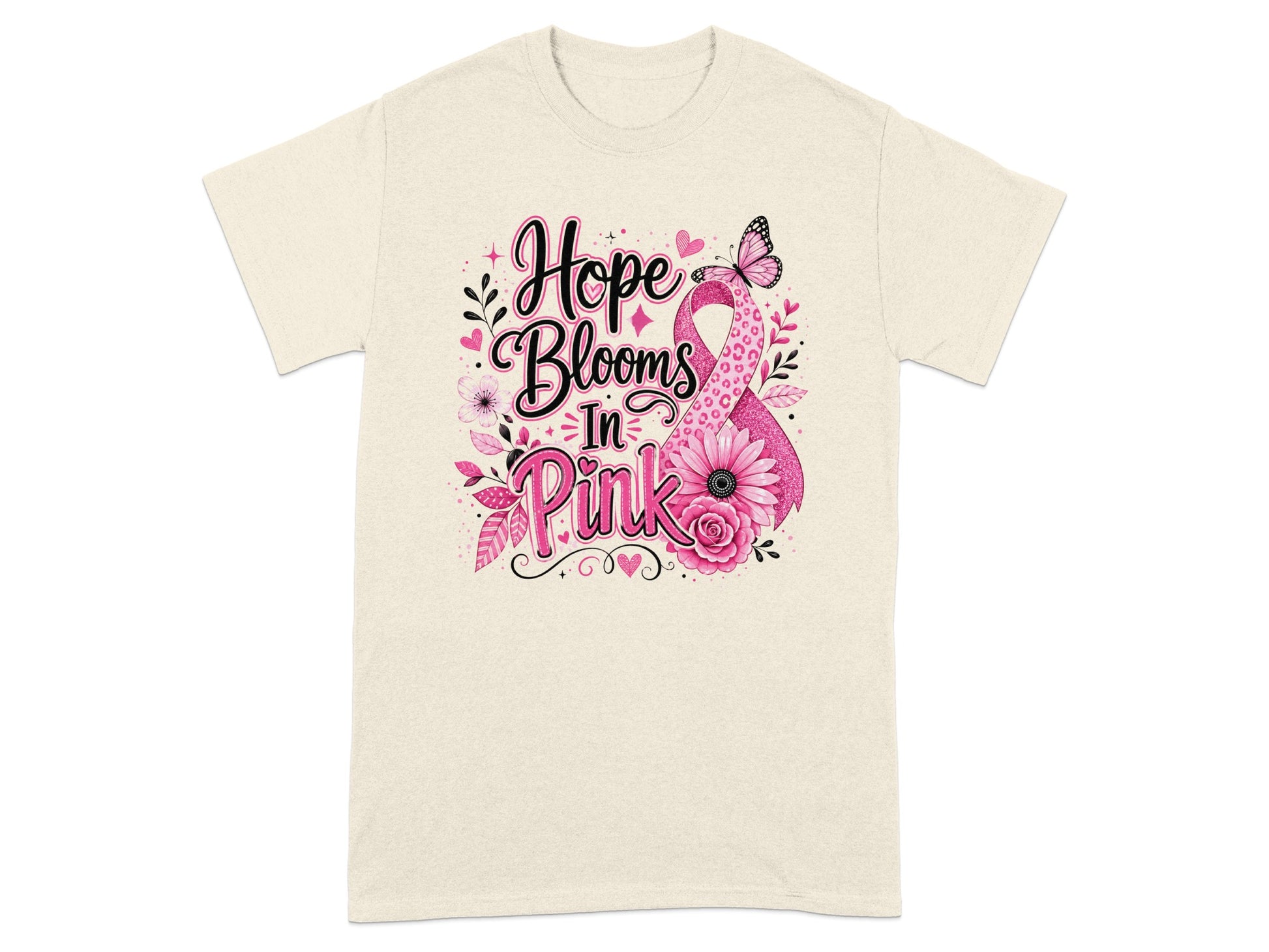 Cream t-shirt with "Hope Blooms In Pink" text and pink ribbon design.