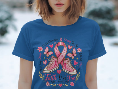 Pink ribbon and sneakers with "Faith Over Fear" text on a blue t-shirt.