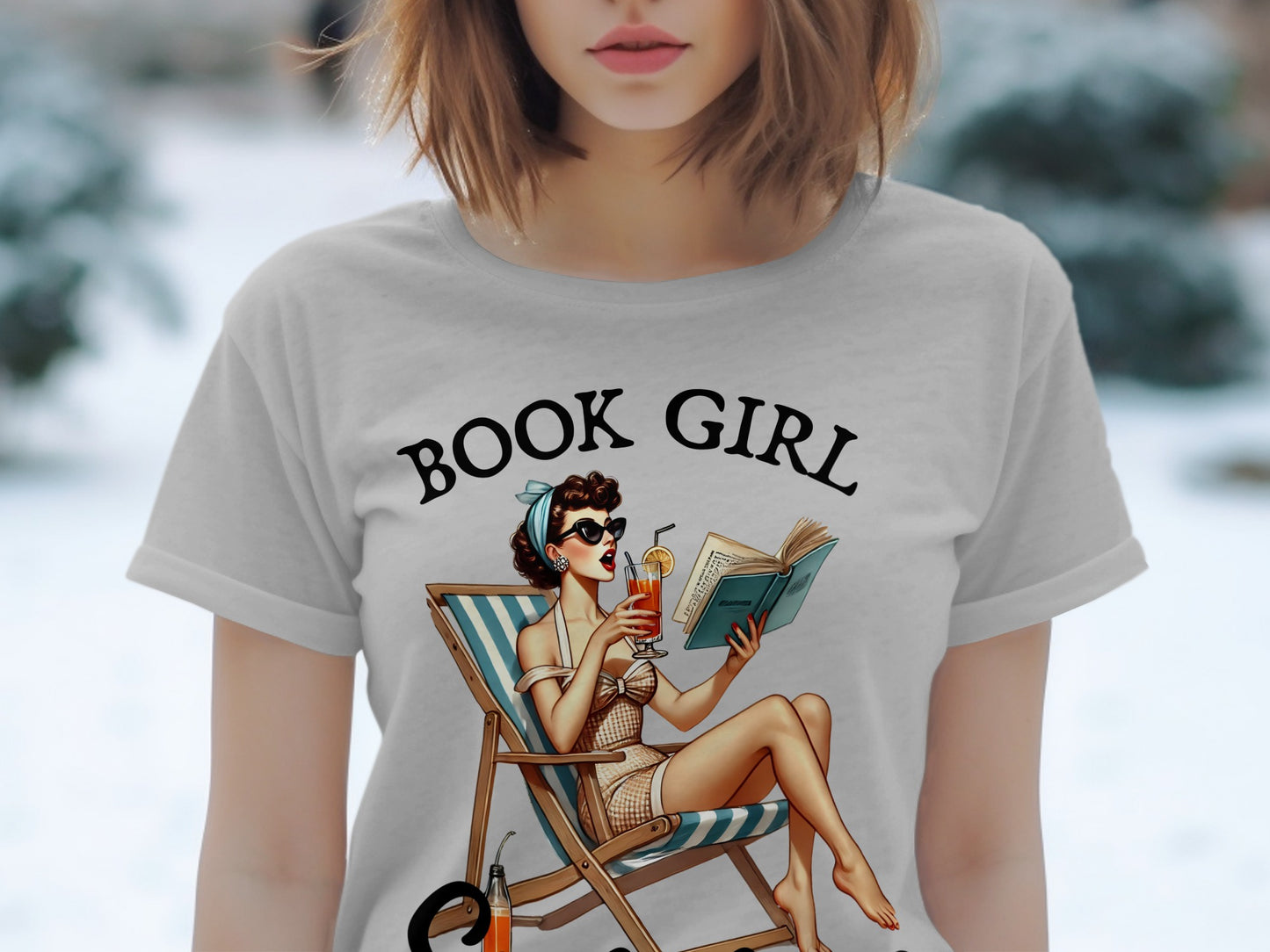 T-shirt graphic with "BOOK GIRL" text and retro pin-up reading on a deck chair.