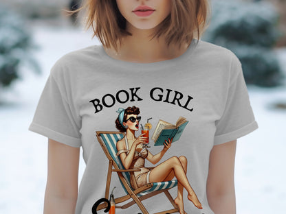 T-shirt graphic with "BOOK GIRL" text and retro pin-up reading on a deck chair.
