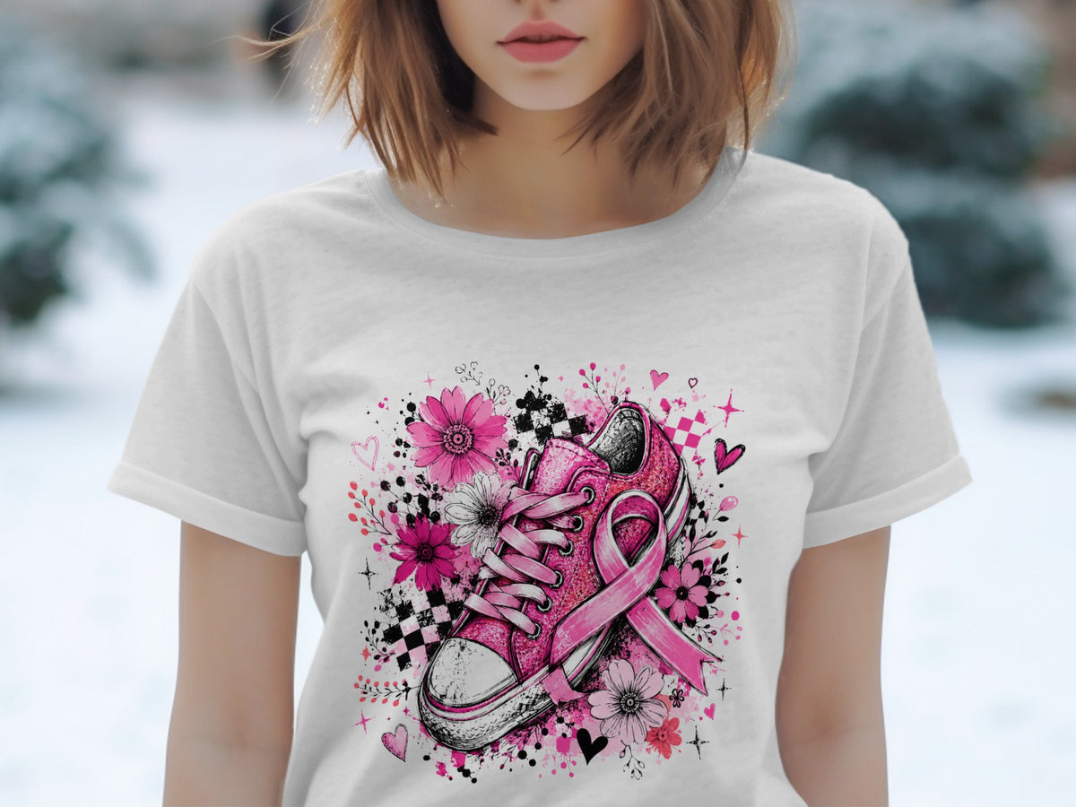 Pink sneaker with flowers, ribbon, and hearts graphic on white t-shirt.