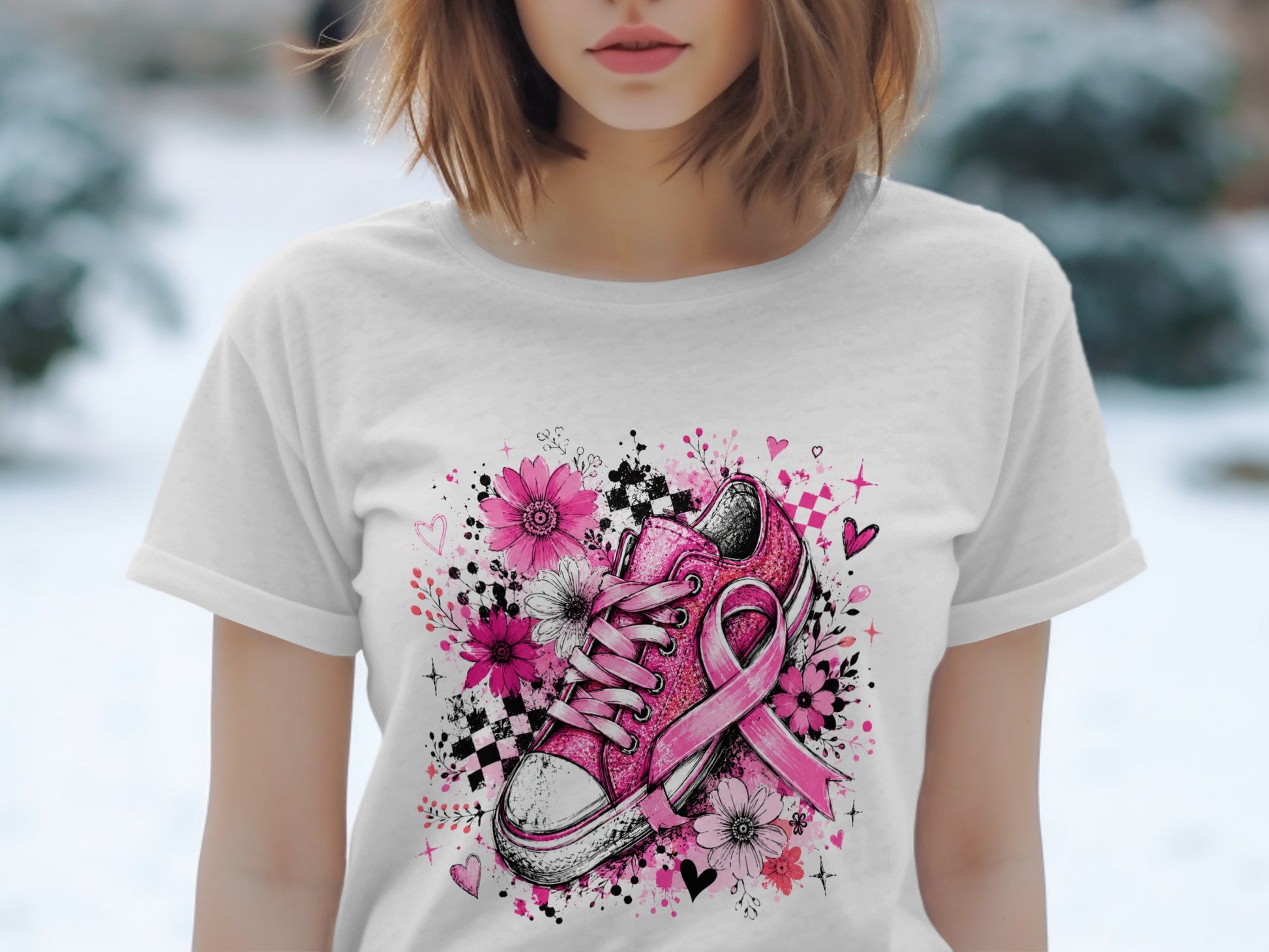 Pink sneaker with flowers, ribbon, and hearts graphic on white t-shirt.
