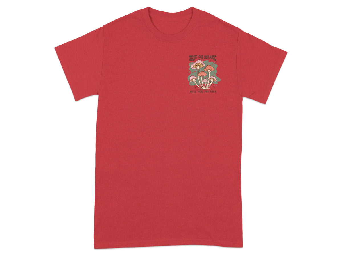 Red t-shirt with mushrooms graphic and text "CREATE YOUR OWN MAGIC WALK YOUR OWN PATH".
