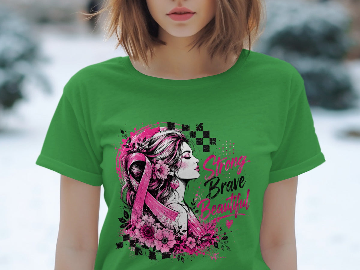 Green t-shirt with artwork of a woman, pink ribbon, flowers, and text "Strong Brave Beautiful".