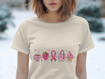Cream t-shirt with cartoon pink coffee cup, strawberry, ribbon, bag, and cupcake.