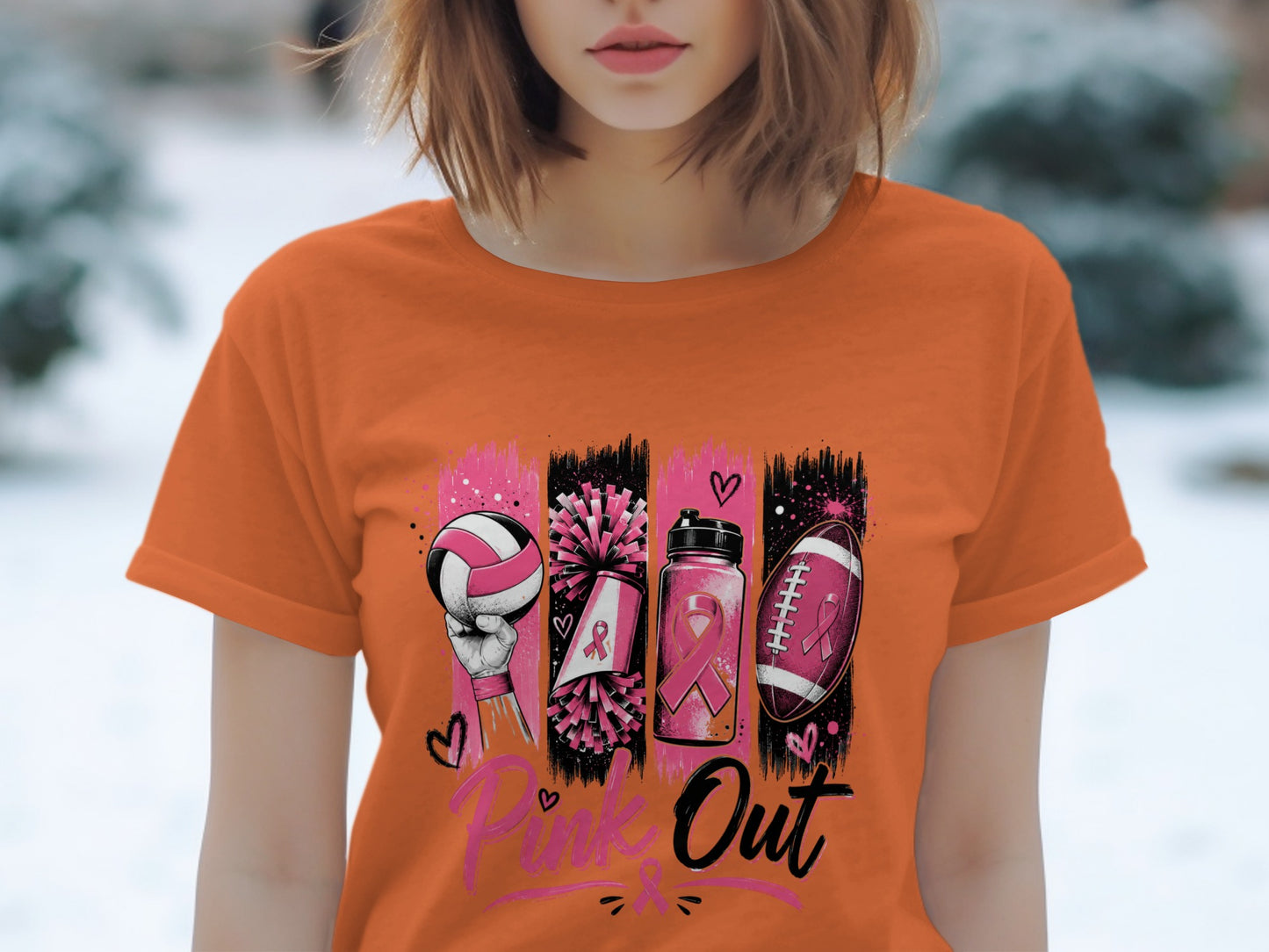 Orange t-shirt with "Pink Out" text and graphic of sports items with pink ribbons.