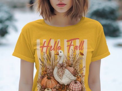 Yellow t-shirt with "Hello Fall" text and a goose surrounded by pumpkins and autumn foliage.