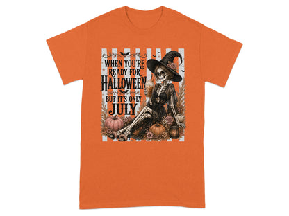 Skeleton wearing witch hat, holding drink, surrounded by pumpkins and flowers, text: "When you're ready for Halloween but it's only July."
