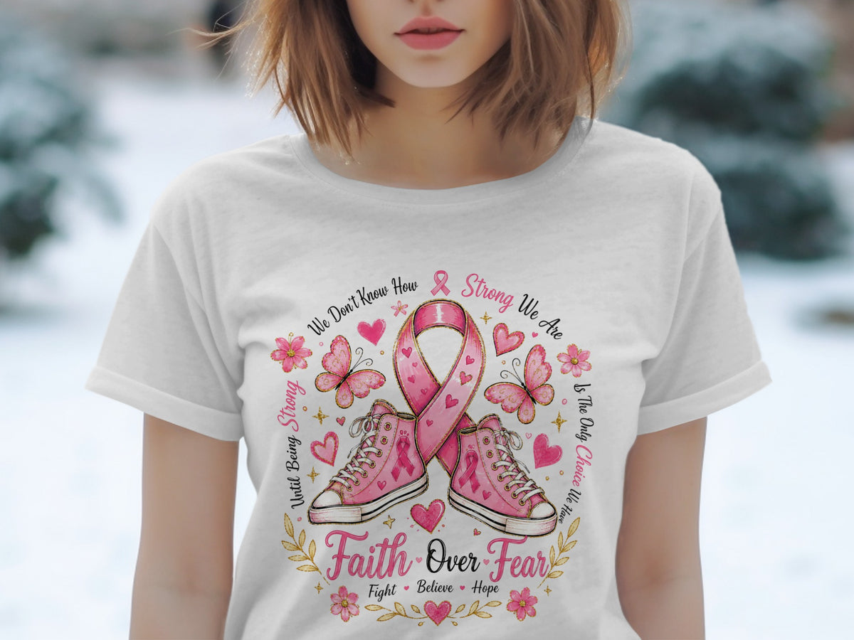 White t-shirt with pink ribbon, sneakers, butterflies, and text about strength and faith.