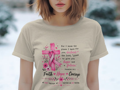 T-shirt with pink ribbon on cross, Bible verse Jeremiah 29:11, and inspirational text.