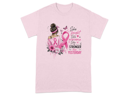 Pink t-shirt with a woman and pink ribbon, reading "She fought, She overcame, She is STRONGER THAN YESTERDAY".