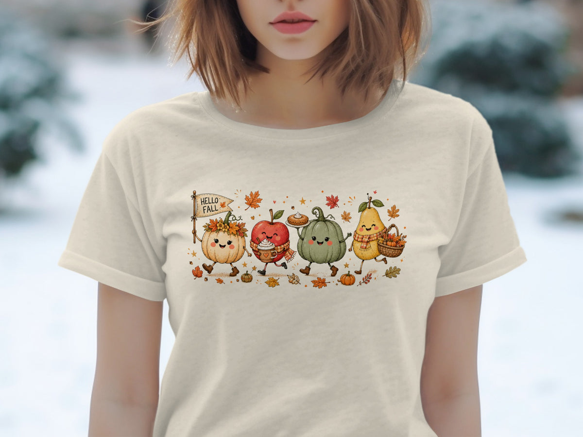 Animated pumpkin, apple, pumpkin, and pear with "HELLO FALL" flag on beige t-shirt.