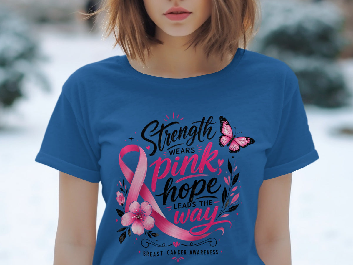 Blue t-shirt with pink ribbon graphic and text "Strength Wears Pink, Hope Leads the Way" and "Breast Cancer Awareness."