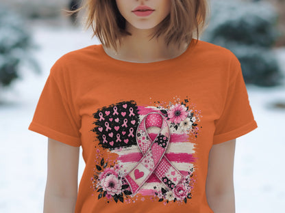 Orange t-shirt with a patched pink ribbon and American flag design.