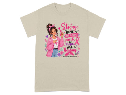 Girl holding pink ribbon with text "Strong in spirit, soft in heart, pink for hope, art for healing".
