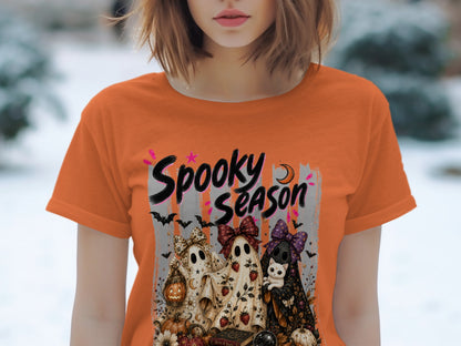 Orange t-shirt with "Spooky Season" text and three ghosts holding a lantern and a cat.