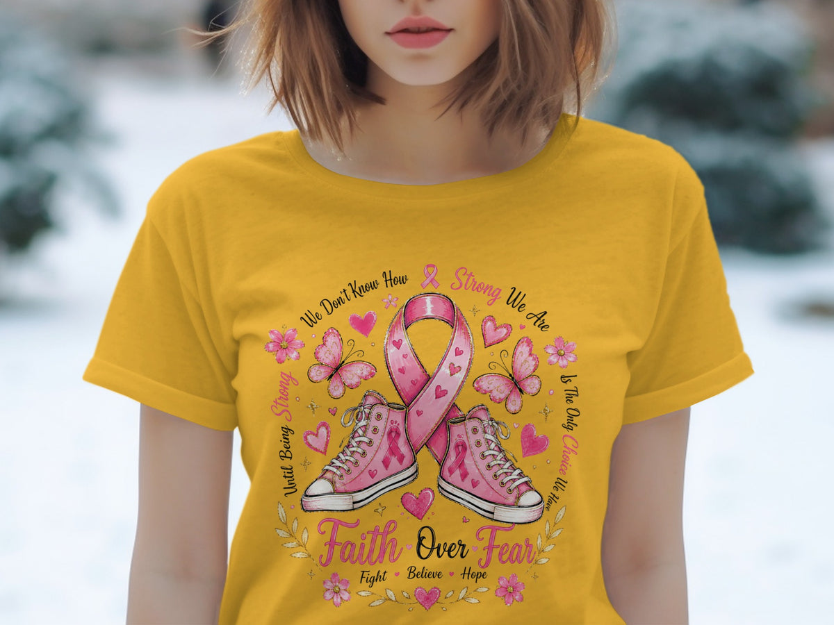 Yellow t-shirt with pink ribbon, sneakers, butterflies, and "Faith Over Fear" text.