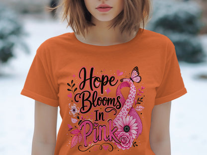 Orange t-shirt with "Hope Blooms In Pink" text and a pink ribbon with flowers and a butterfly.