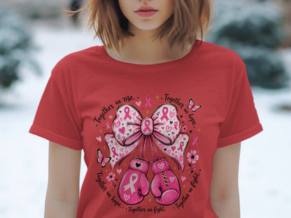 Red t-shirt with pink ribbon design featuring boxing gloves and butterflies with text "Together we rise. Together we hope. Together we fight."