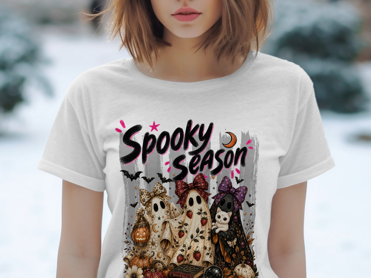White t-shirt with "Spooky Season" graphic featuring three ghosts, a cat, pumpkins, and Halloween motifs.