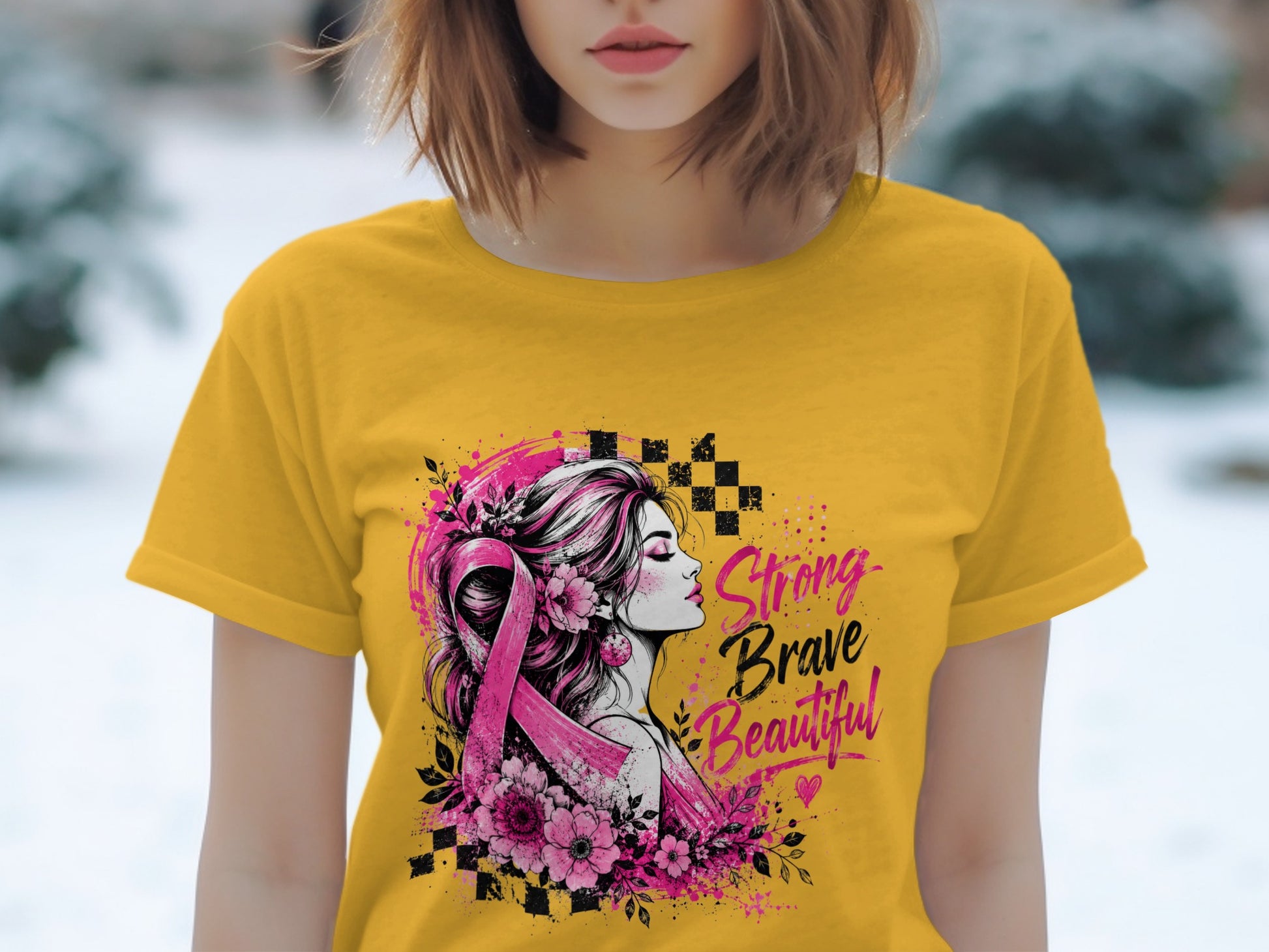 Yellow t-shirt with a graphic of a woman, a pink ribbon, and the words "Strong Brave Beautiful".
