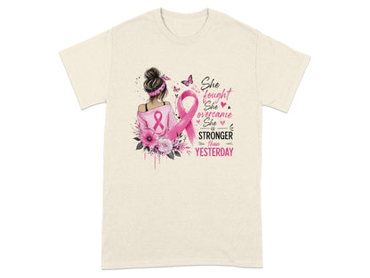 Cream t-shirt with "She fought, she overcame, she is stronger than yesterday" text and ribbon.