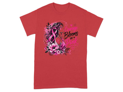 Pink t-shirt with graphic of woman, pink ribbon, and text "Courage Blooms in Pink".