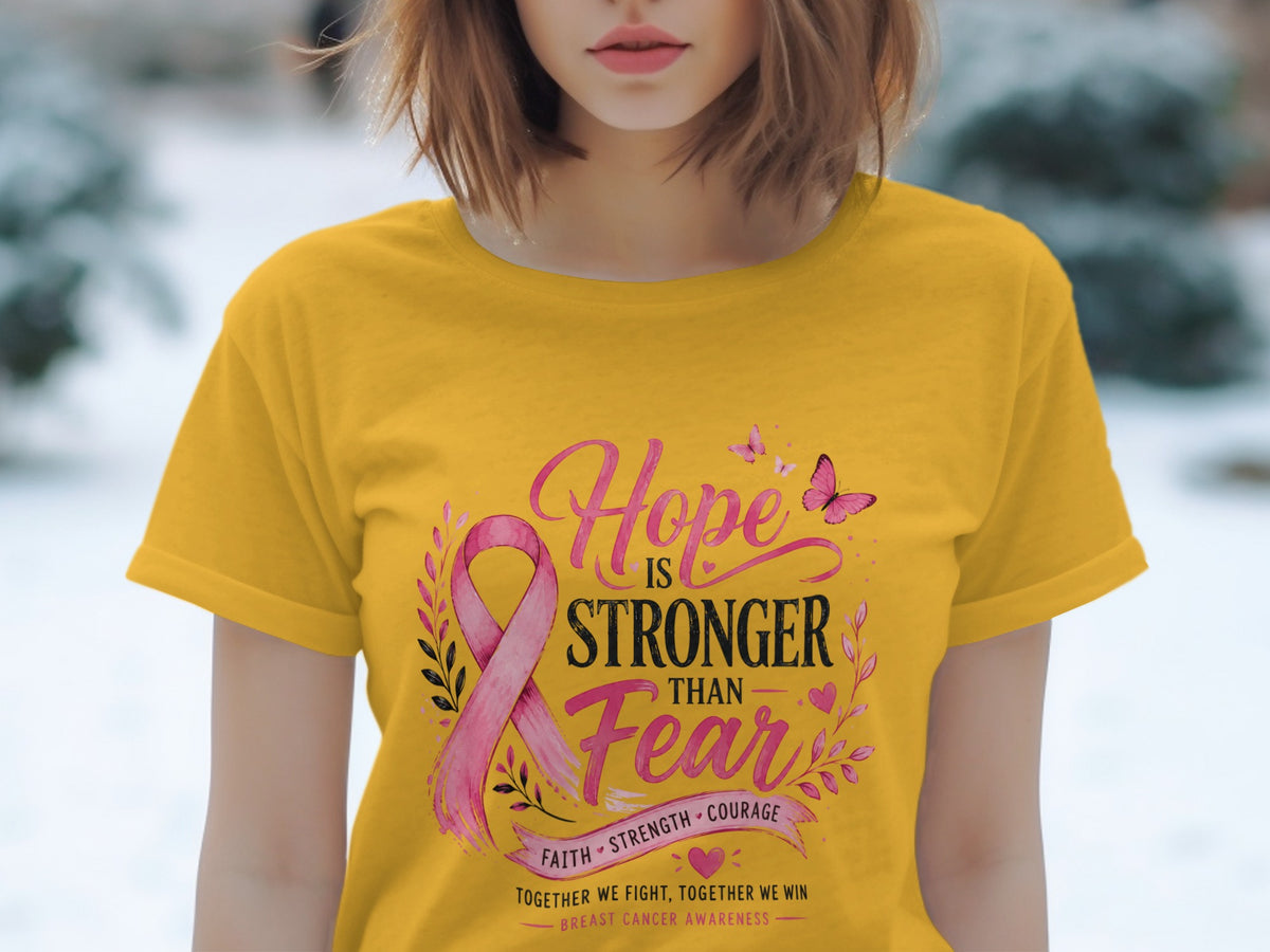 Yellow t-shirt with pink ribbon and text "Hope is stronger than Fear".
