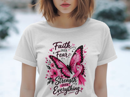 White t-shirt with pink butterfly, flowers, and "Faith Over Fear Strength Over Everything" text.