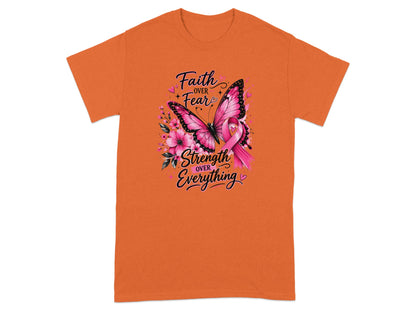 Orange t-shirt with a pink butterfly, flowers, and breast cancer ribbon. Text reads "Faith over Fear" and "Strength over Everything."