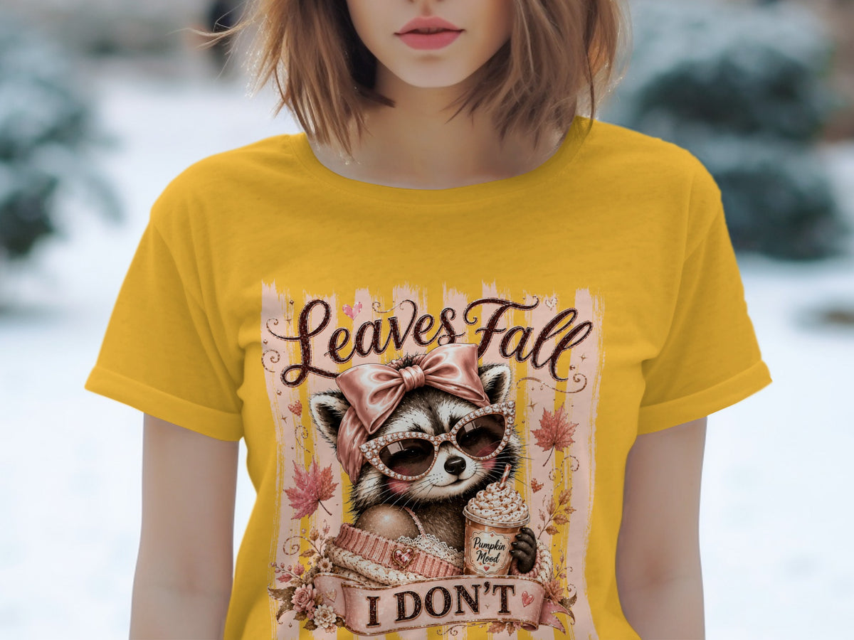 Yellow t-shirt with a graphic of a raccoon holding a coffee cup, text "Leaves Fall I DON'T".