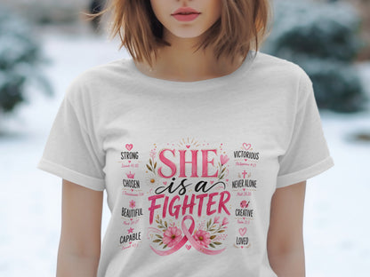 White t-shirt with "SHE is a FIGHTER" text, pink ribbon, and positive attributes.