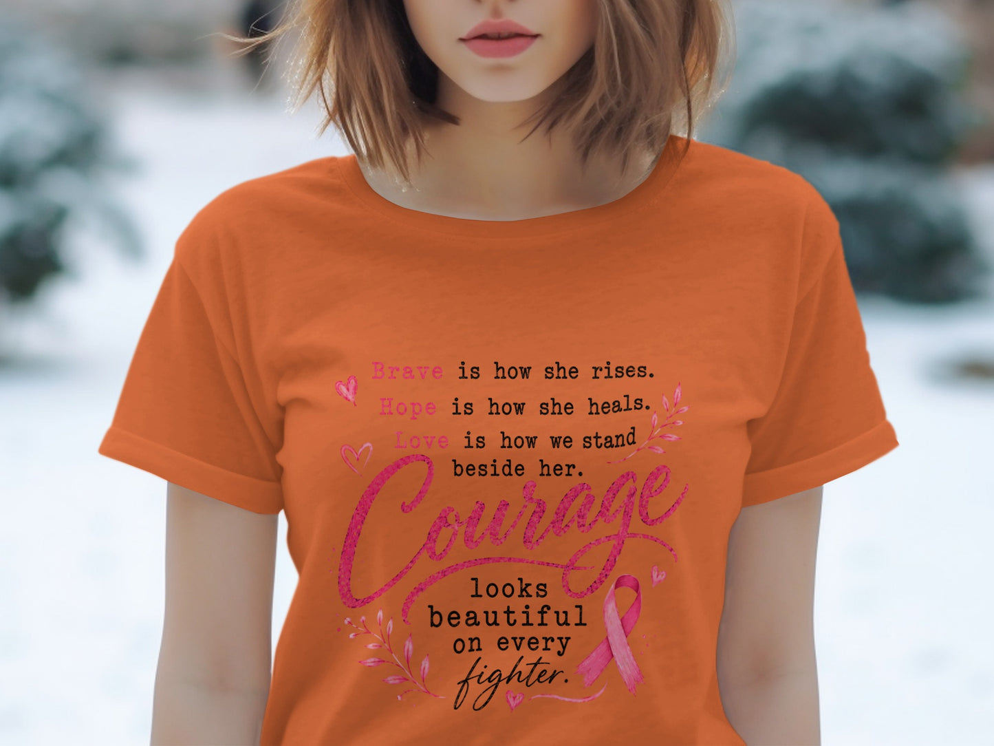 Orange t-shirt with text about courage, hope, and love, featuring a pink ribbon.