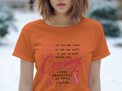Orange t-shirt with text about courage, hope, and love, featuring a pink ribbon.