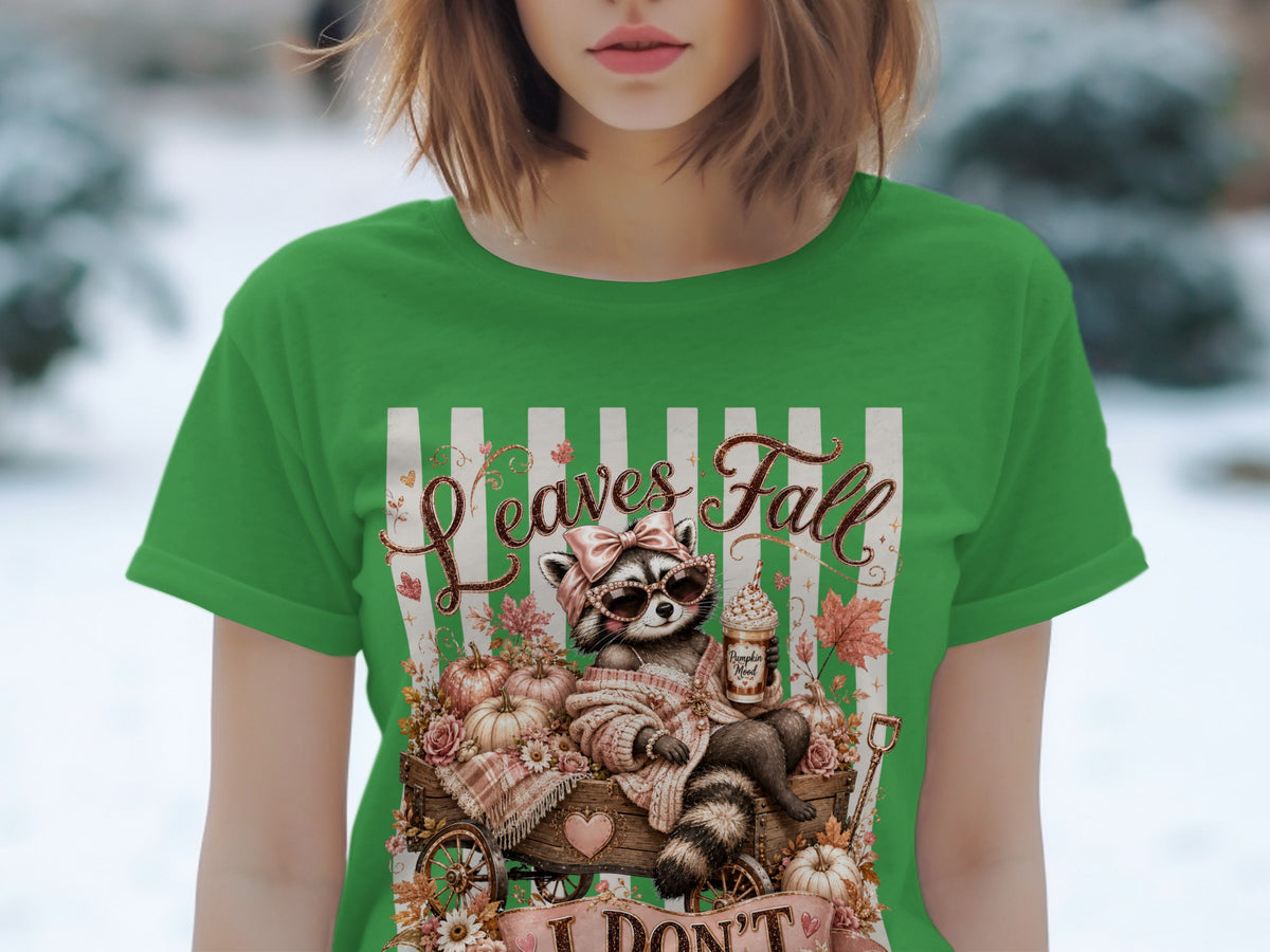 Raccoon with sunglasses and bow, sitting in wagon with pumpkins and leaves, text "Leaves Fall".