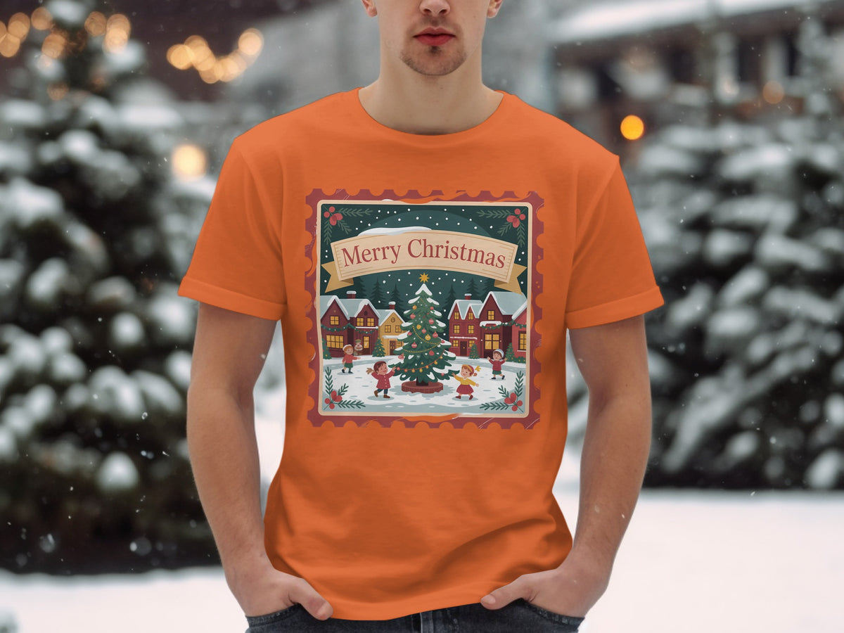 Orange t-shirt with a Christmas scene featuring a tree and children, inside a stamp border.