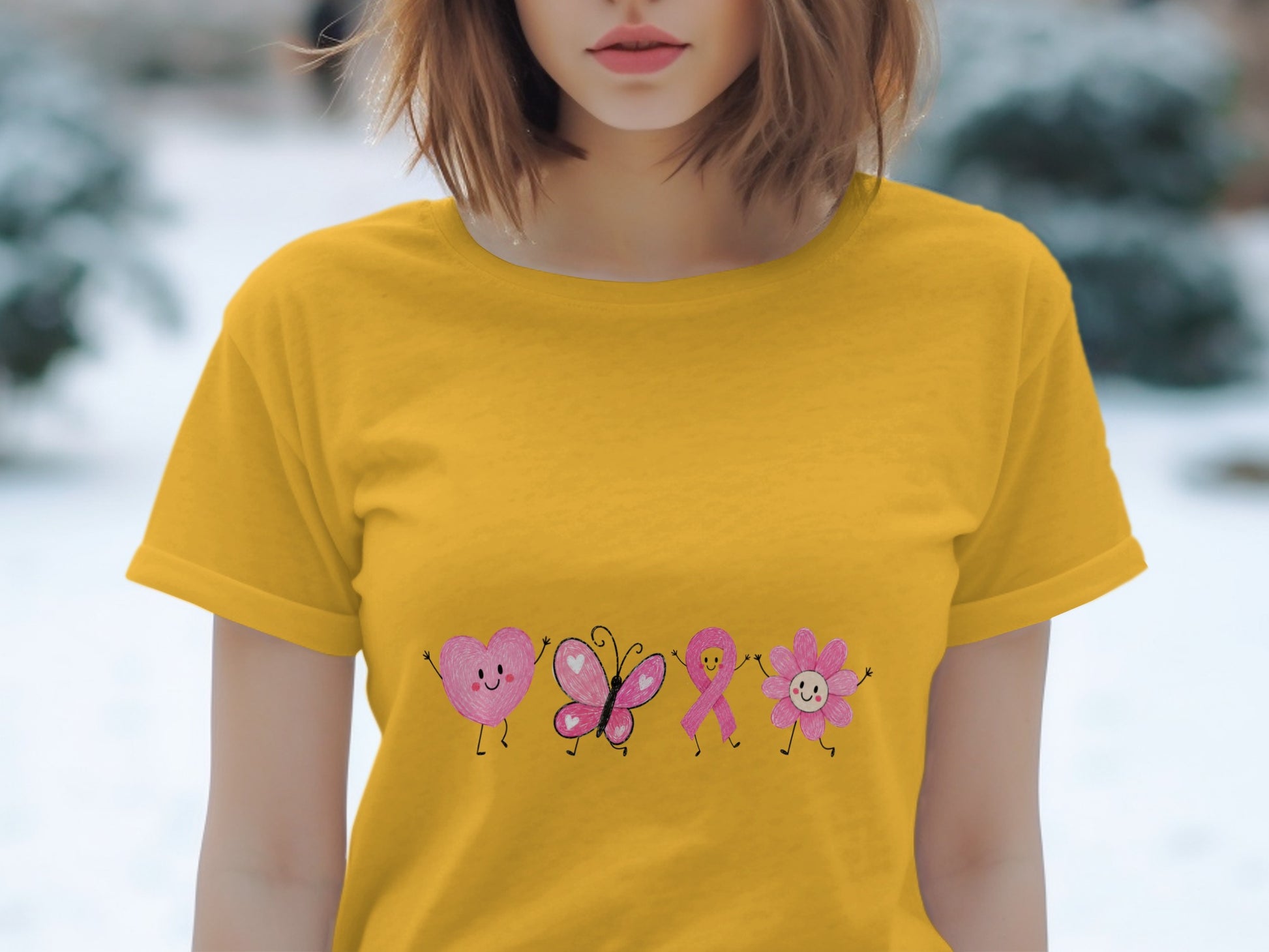 Yellow t-shirt with pink heart, butterfly, ribbon, and flower designs.