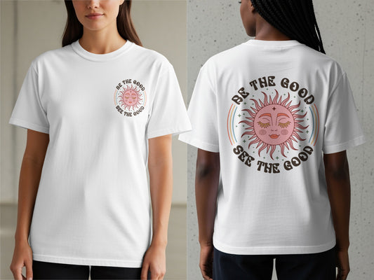 White t-shirt with pink sun graphic and "Be the Good See the Good" text.