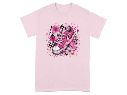 Pink t-shirt with a graphic of a pink sneaker with a pink ribbon and floral accents.