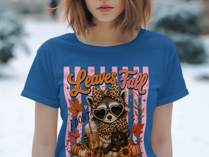Raccoon with sunglasses and cat, holding coffee. Text: "Leaves Fall, I Don't".