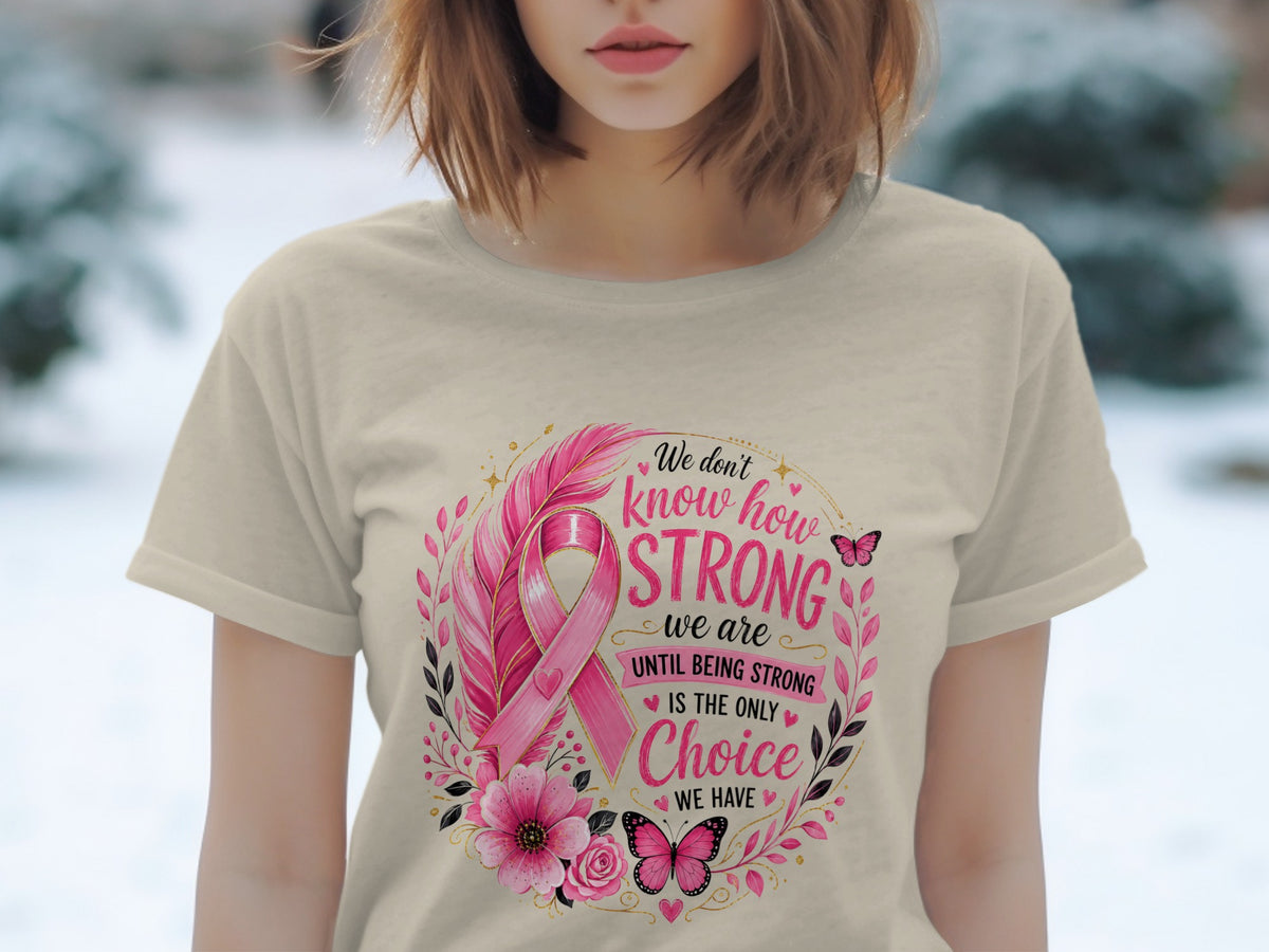 T-shirt with pink ribbon, feathers, flowers, butterflies, and text "We don't know how STRONG we are UNTIL BEING STRONG IS THE ONLY Choice WE HAVE".