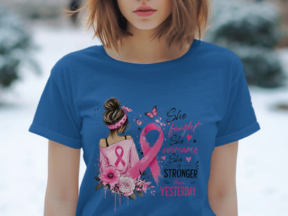 Blue t-shirt with pink ribbon and text "She fought, She overcame, She is stronger than yesterday."