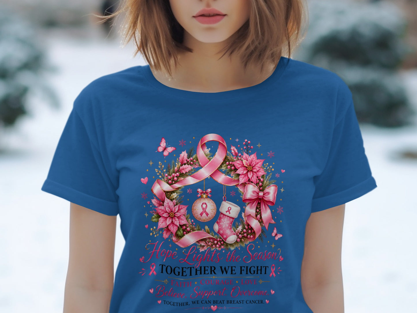 Blue t-shirt with holiday wreath, pink ribbon, and text "Hope Lights the Season."